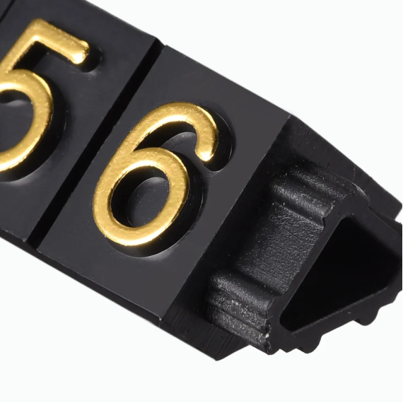 Black plastic strip with gold numbers on a white background