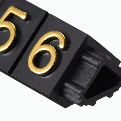 Black plastic strip with gold numbers on a white background