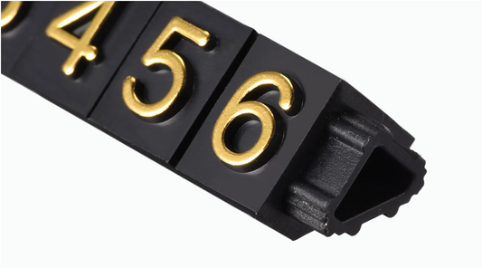 Black plastic strip with gold numbers on a white background