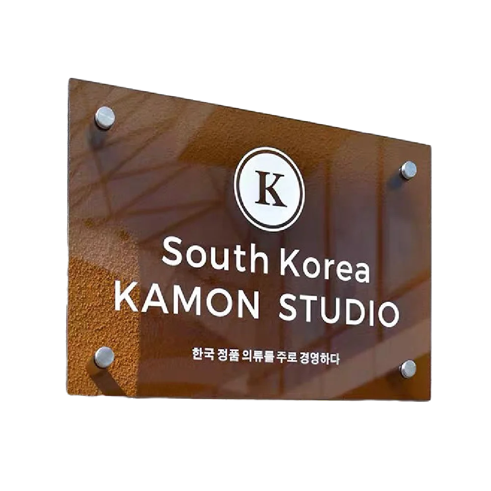 Glass sign with 'South Korea KAMON STUDIO' and a logo on a white background