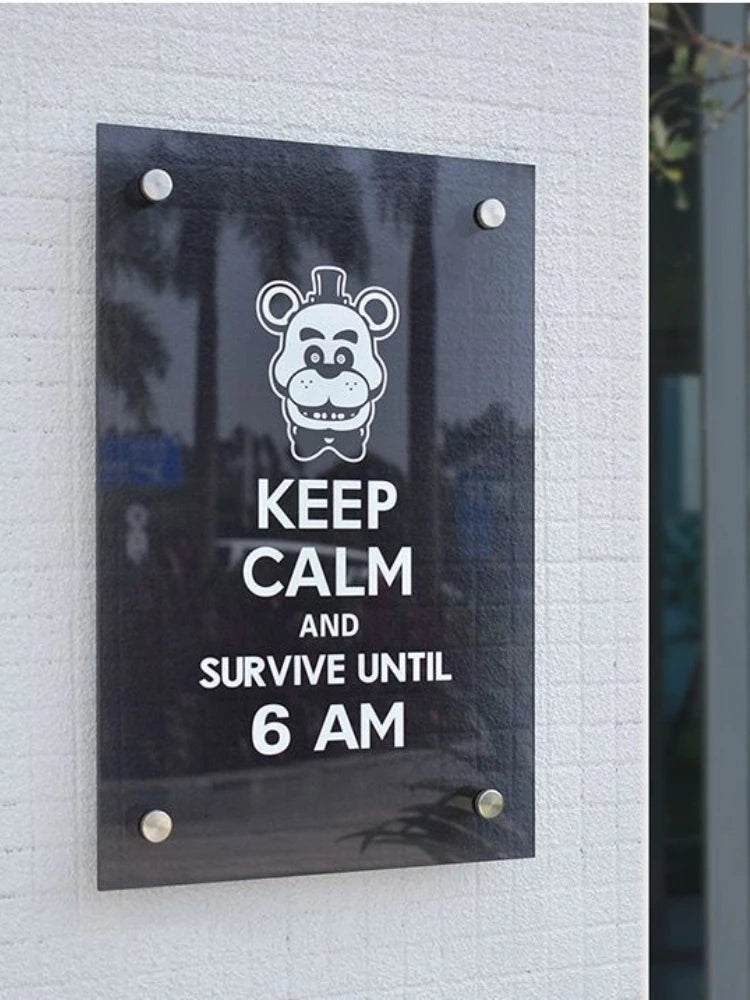 Sign with cartoon bear face and text 'Keep Calm and Survive Until 6 AM' on a light gray wall.