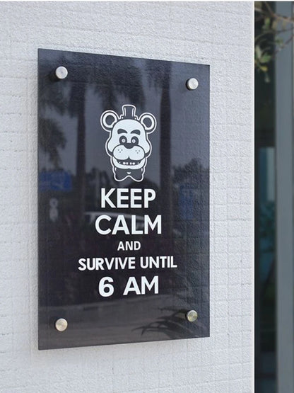 Sign with cartoon bear face and text 'Keep Calm and Survive Until 6 AM' on a light gray wall.
