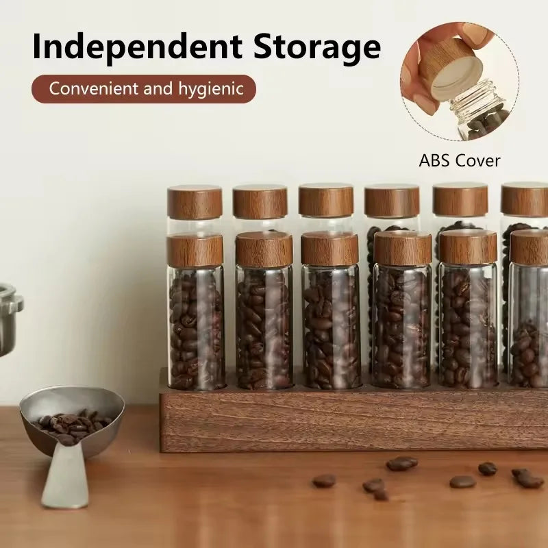 Set of glass jars with lids containing coffee beans on a wooden stand.