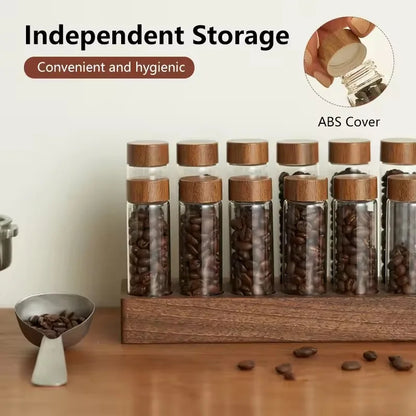Set of glass jars with lids containing coffee beans on a wooden stand.