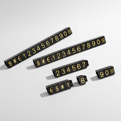 Set of black number tiles with yellow symbols 