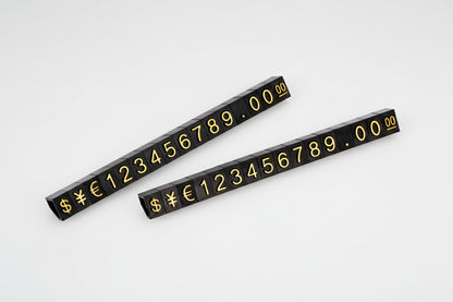 Two black number strips with gold numbers and symbols 