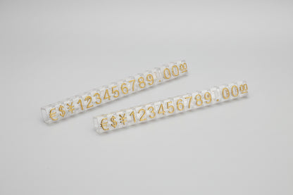 Two rolls of gold number stickers on a white background