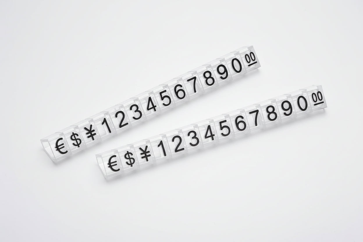 Two strips of adhesive numbers and currency symbols on a white background